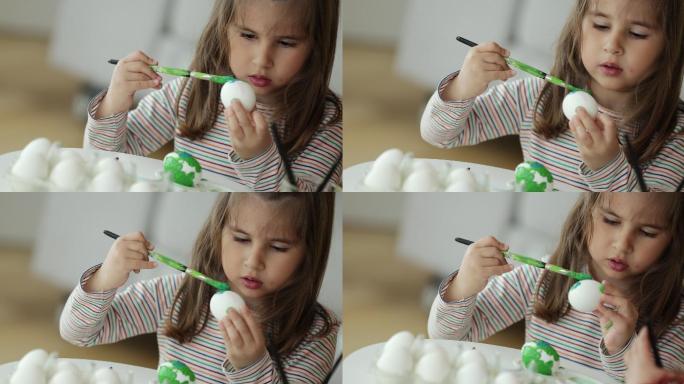 在家学习用刷子画复活节彩蛋的孩子