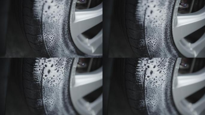 在汽车轮胎上喷涂清洁剂，用于清洁和打蜡轮胎。