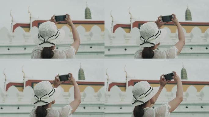 泰国复古风格的女人正在为她的周末拍摄泰国曼谷著名寺庙Wat Phra Kaeo的照片泰国复古风格的女