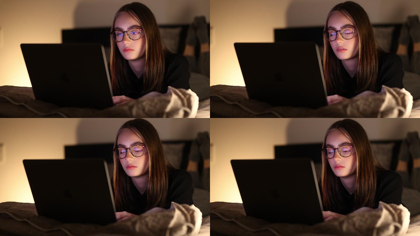 严肃的少女晚上在床上用笔记本电脑读坏消息4K
