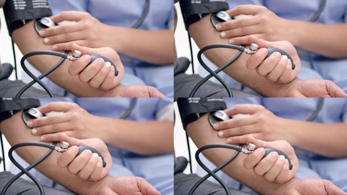 护士用血压监测设备测量患者血压的手