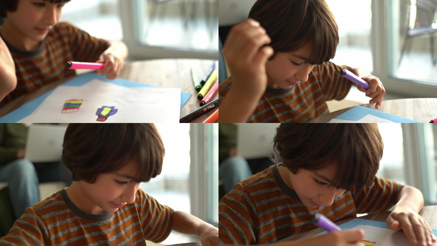 男孩在家画画作业
