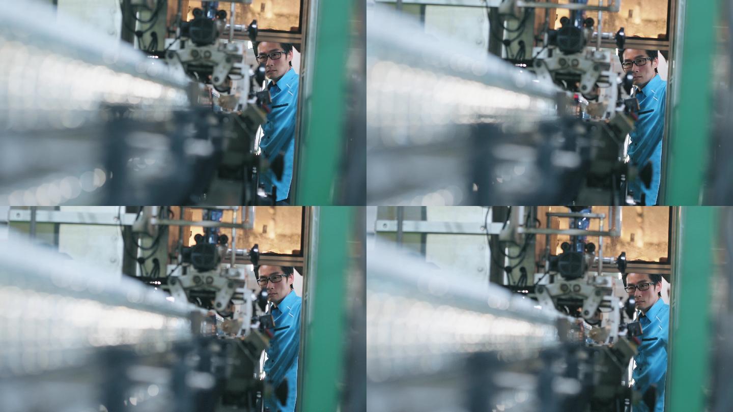 在瓶装厂矿泉水饮用水厂操作贴标机的亚裔中国男性生产线工人