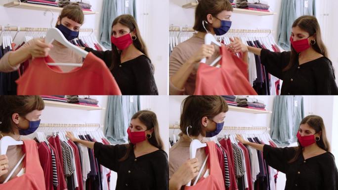 女性戴着口罩在服装店购物