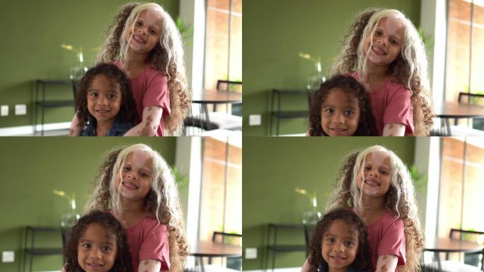 兄弟姐妹在家拥抱的照片——包括一个患有斑秃症的女孩