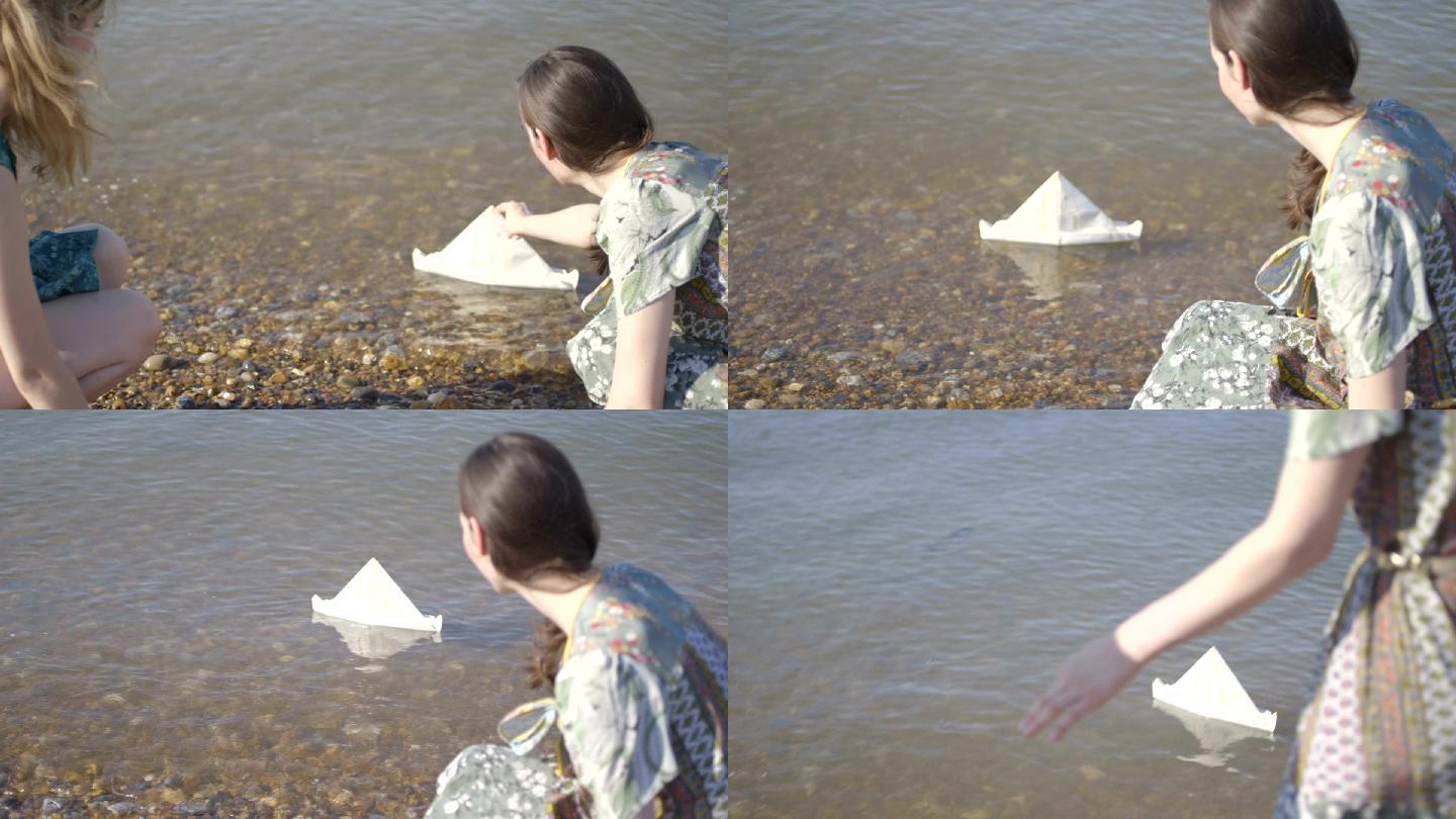 海滩上的年轻女性美女水边放纸船美女玩水嬉