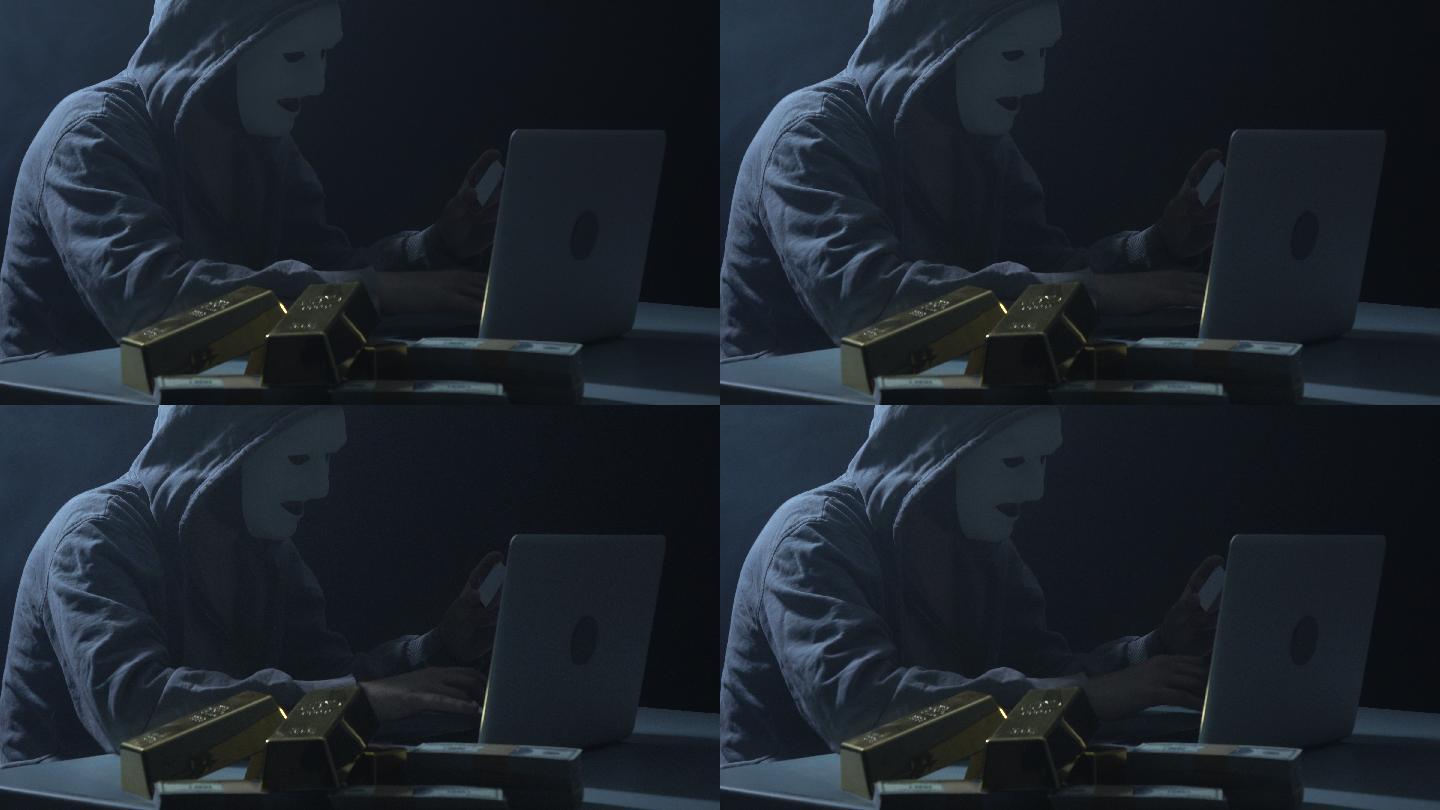 一名男子身穿连帽衬衫，在黑暗中使用笔记本电脑进行黑客攻击