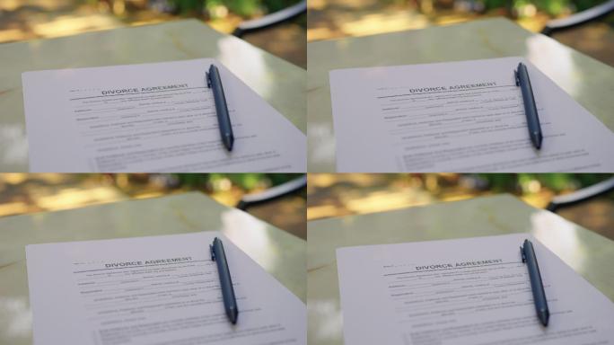 离婚协议书用钢笔静静地放在秋园里