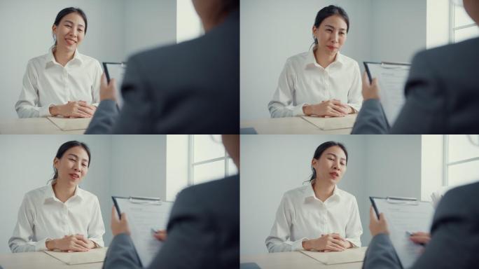 年轻的亚洲女商人在办公室讨论简历时正在面试一份工作。