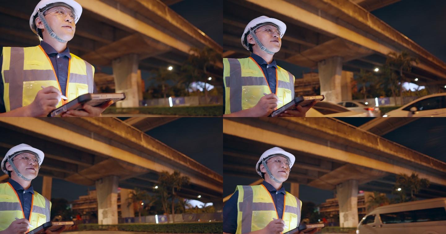 专业的亚洲土木工程夜班工作，使用数字平板监控道路建设项目的进度。工长检查和监督互通式高速公路的施工。