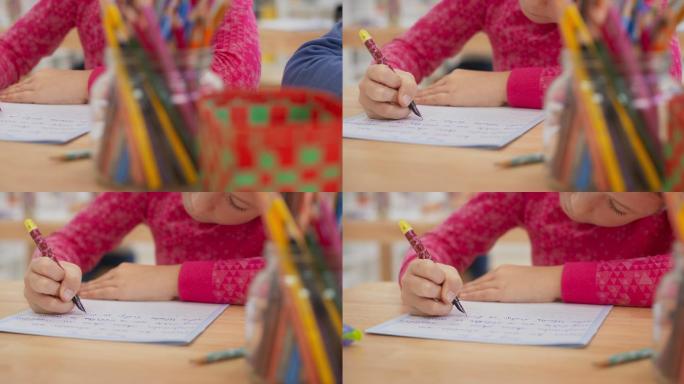 学生用钢笔在笔记本上写字