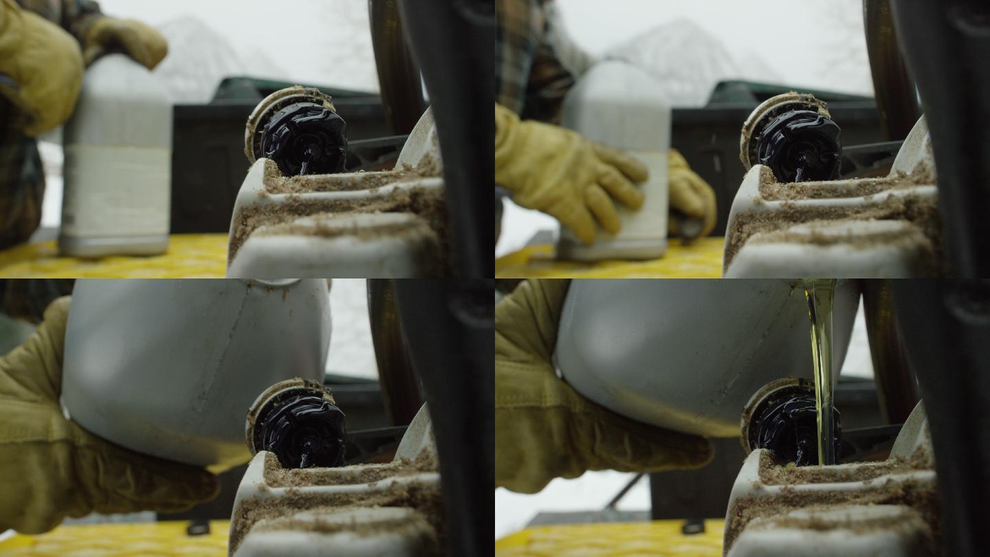 一个戴着手套的人在山上的一个下雪的冬日用链锯装满了油条