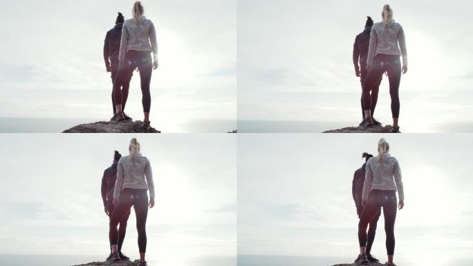 一对夫妇站在山顶观看风景的4k视频片段