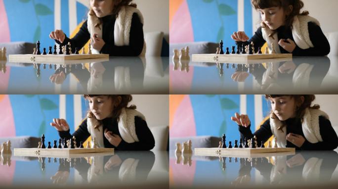 小女孩在下棋时思考和移动棋子