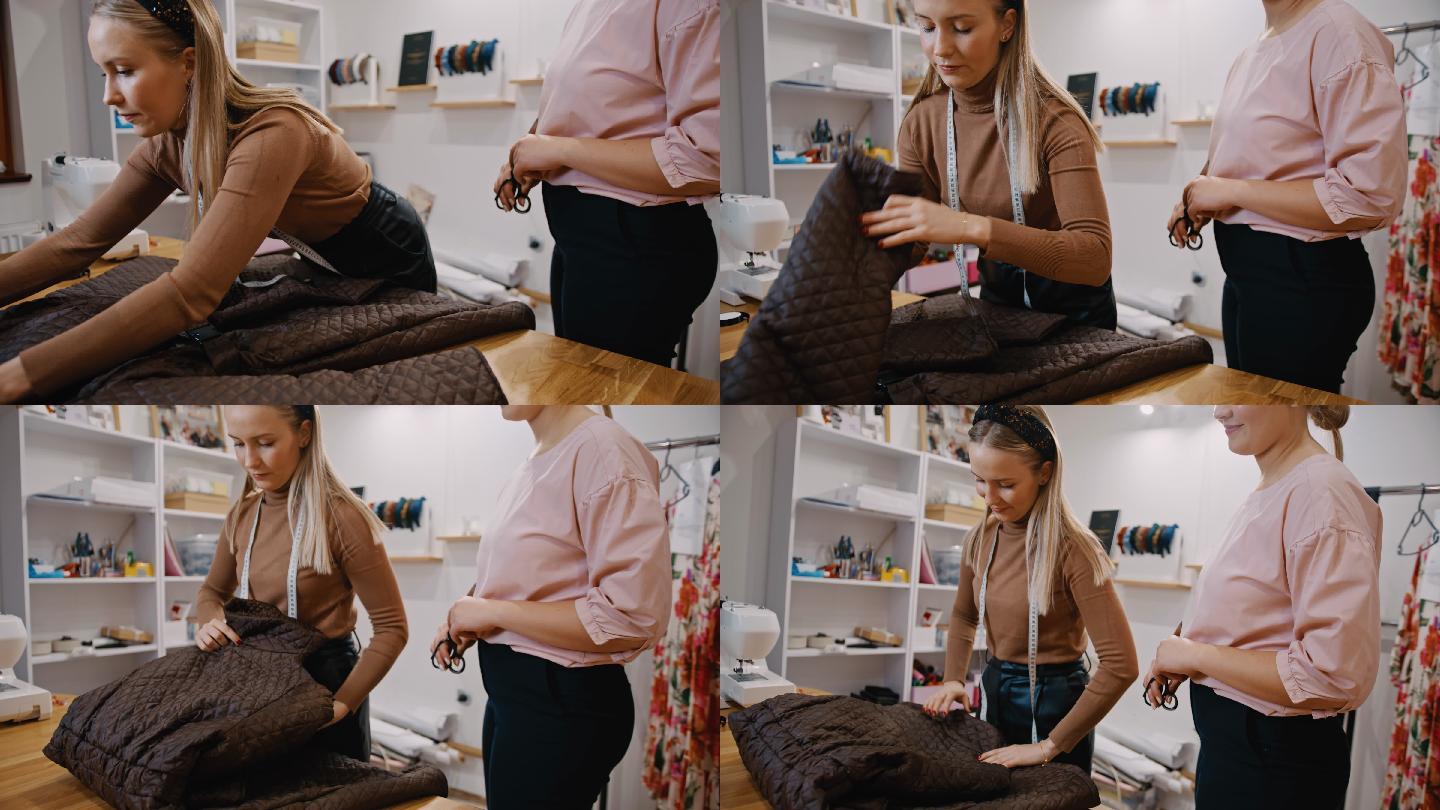SLO MO年轻的女时装设计师在她的工作室里折叠一件夹克