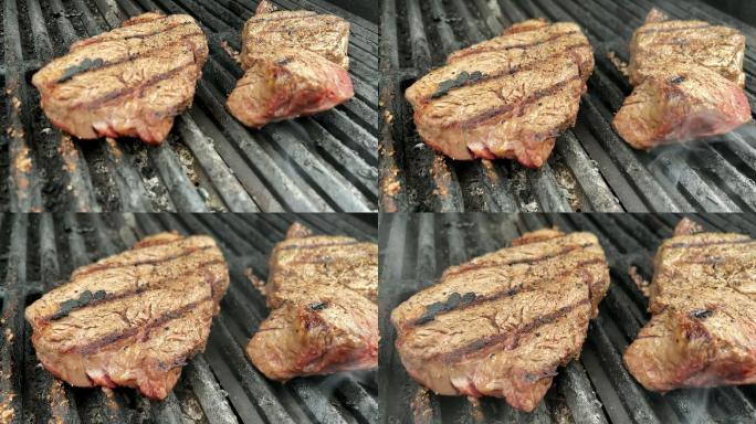 用烟雾慢镜头在木炭烤架上烤上等调味的牛里脊牛排