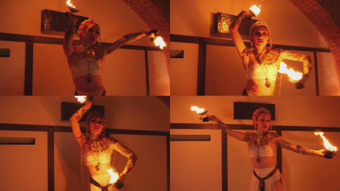 一位异国情调的火舞演员在火光绘成的房间里的远景