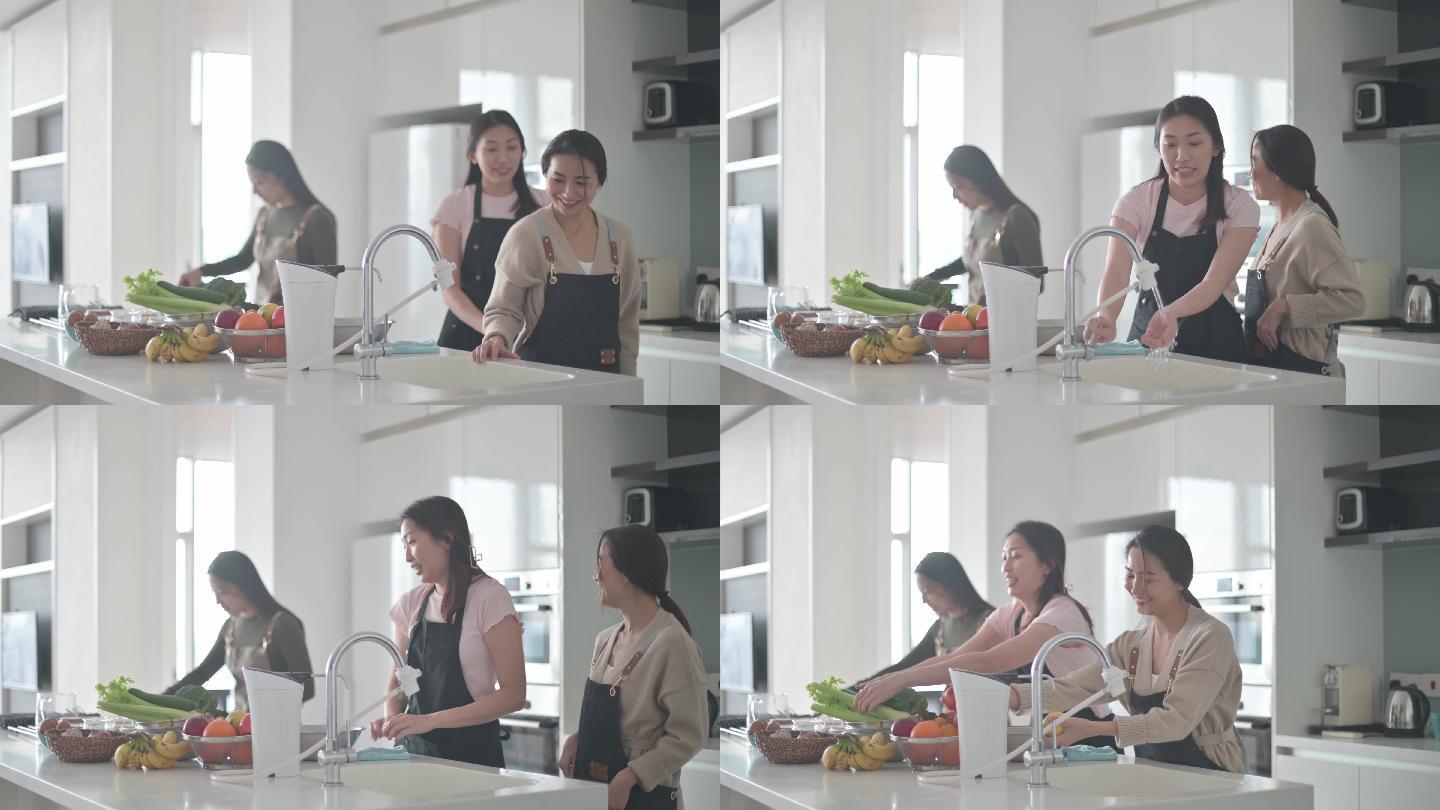 3名亚裔中国女性朋友周末在厨房柜台在家做饭