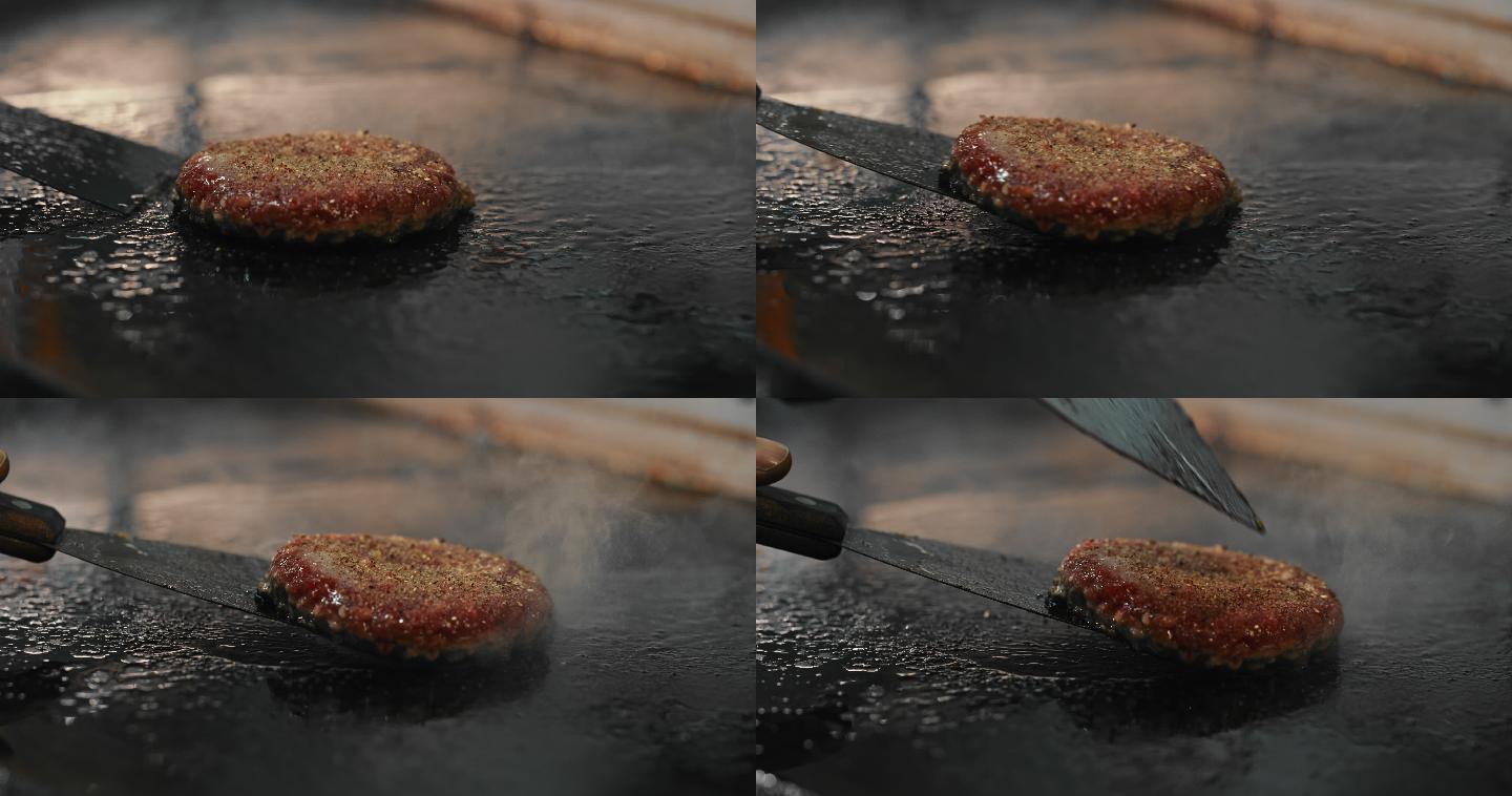 一个厨师在烤架上翻转汉堡肉饼的4k视频片段