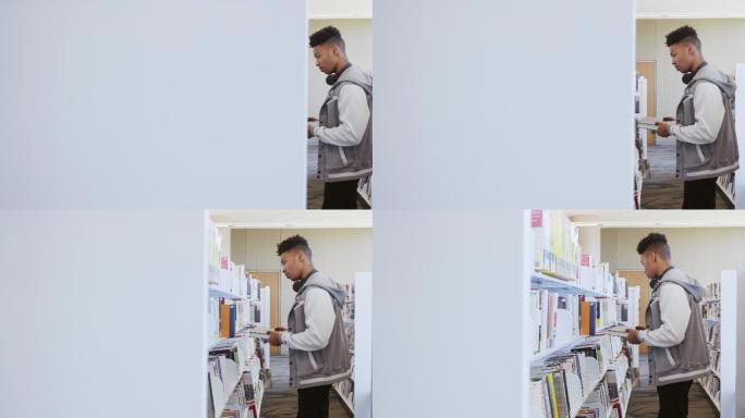男大学生在图书馆的书架上找书