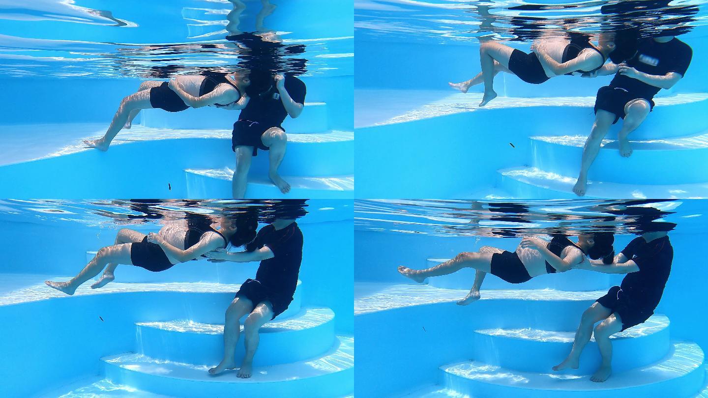 水下亚裔中国男子拉着和帮助妻子漂浮在游泳池上放松运动呼吸运动为他们的新生儿做准备