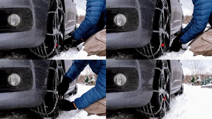汽车陷在雪地里，有人在轮胎上加了防滑链