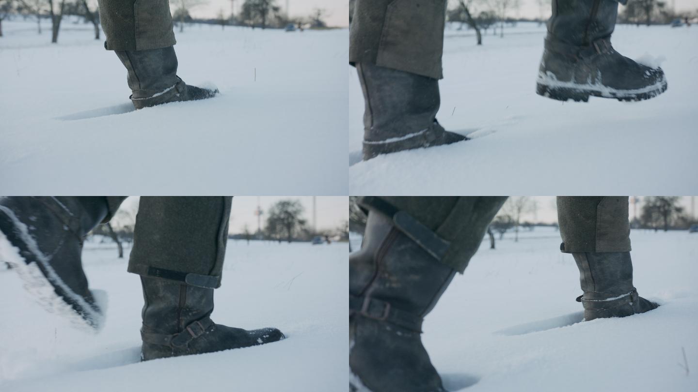 一个男人的靴子在白雪覆盖的田野里行走的特写镜头