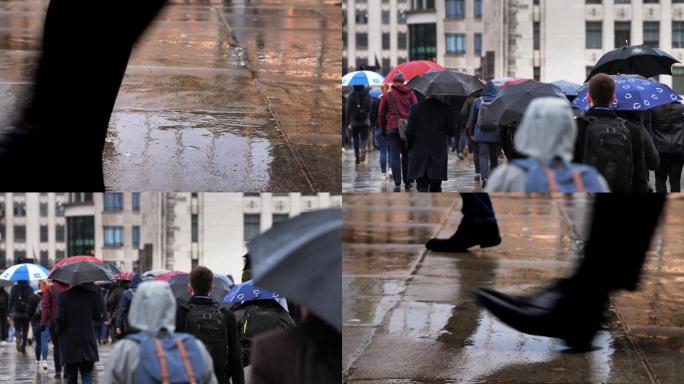 两只脚和雨中带着雨伞的通勤者。