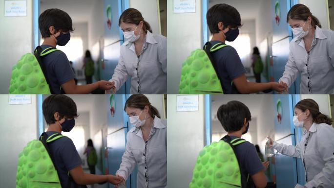 教师在进入教室前测量学生的体温——使用口罩