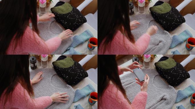 一名女子正在拍摄她的针织服装产品，以便在网上销售