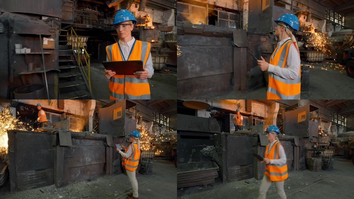 DS女安全工程师手持数字平板电脑穿过铸造厂