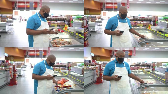戴口罩的男子在超市用智能手机检查产品