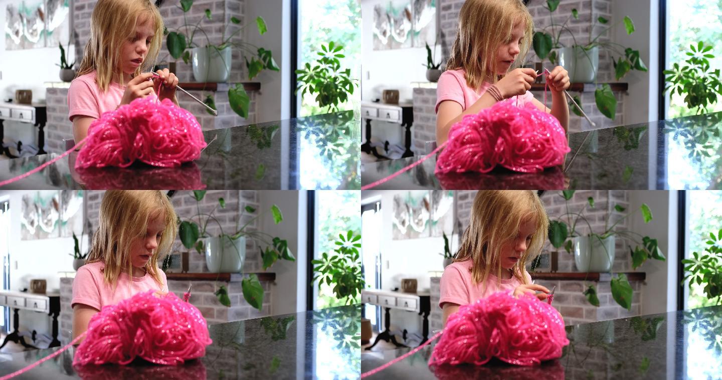 用粉色羊毛编织的年轻女孩