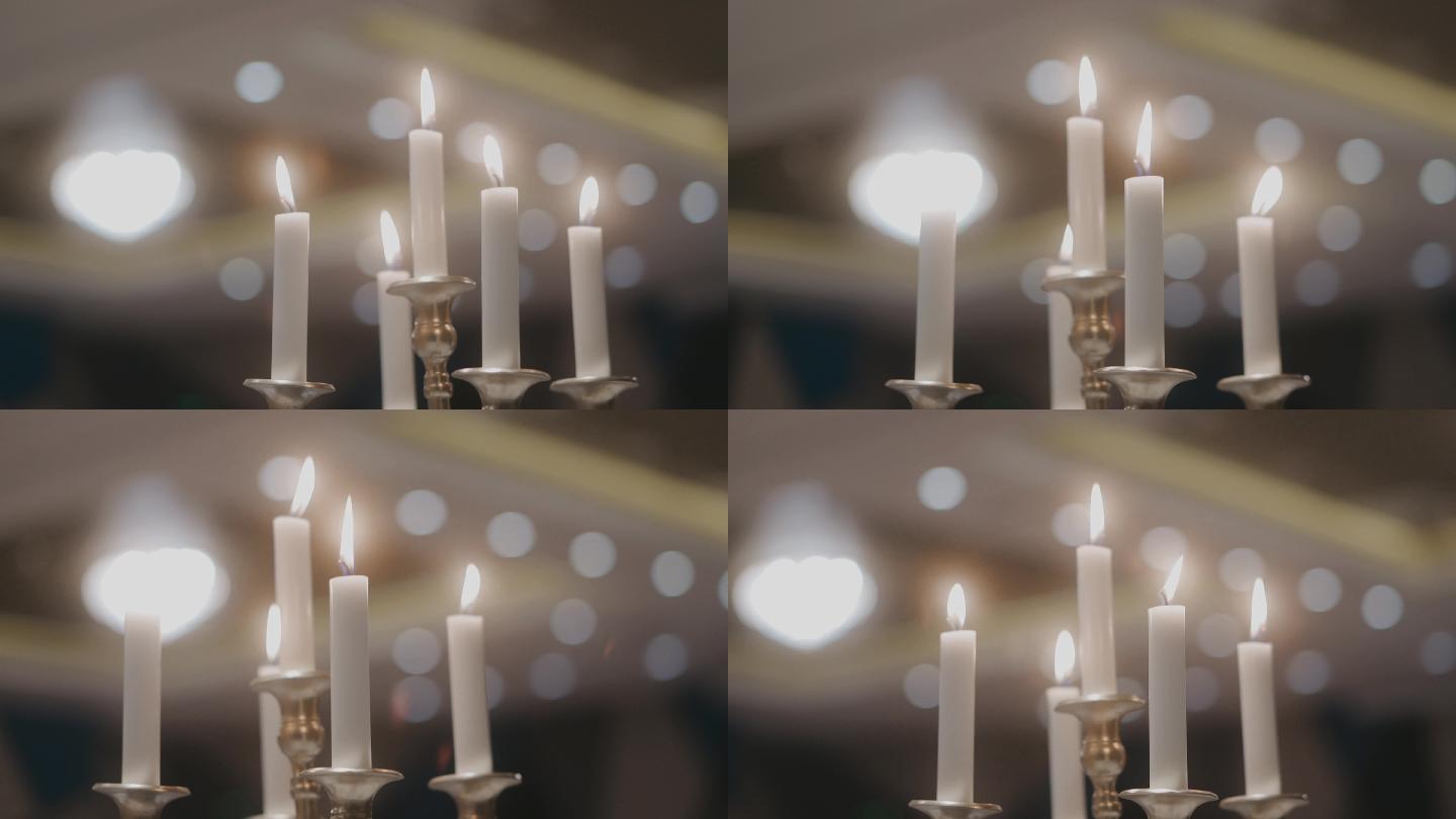 美丽的白色蜡烛和烛台，背景散焦