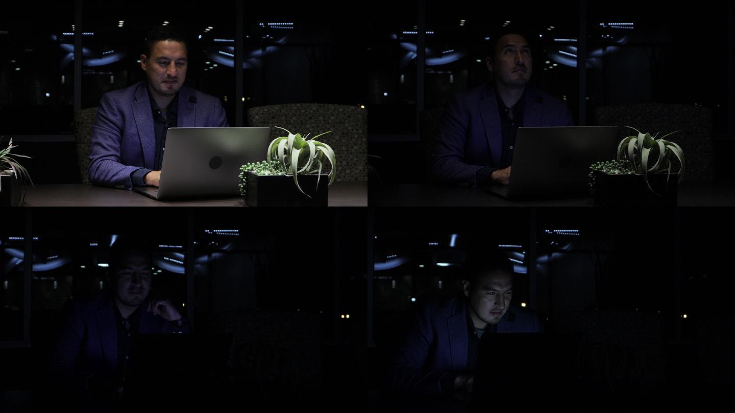 在停电期间，一名成年商人和一名办公室工作人员正在用笔记本电脑拍摄暴风雨夜的4K视频系列