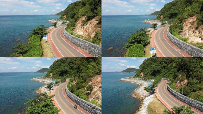 一辆汽车在夏天沿着岛上的公路行驶的景象