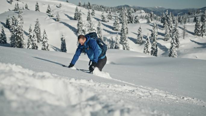 斯洛莫山徒步旅行者在坎尼克-萨文加阿尔卑斯山的一个斜坡上涉过新鲜的积雪