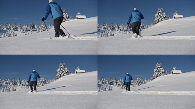 斯洛莫山徒步旅行者在山上的新雪中跋涉