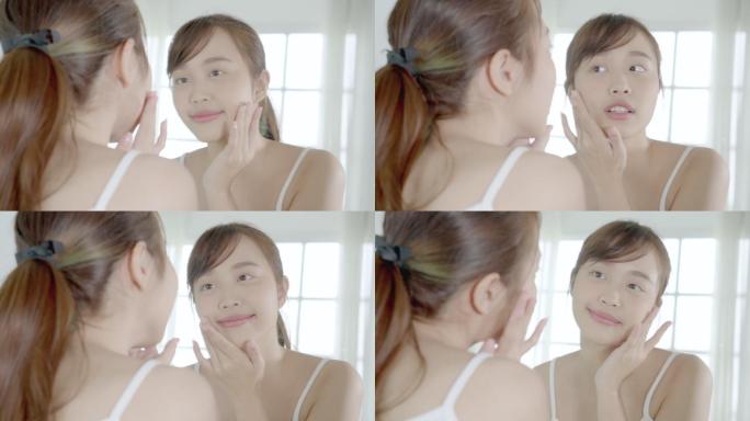 美丽的年轻亚洲女性乐于在面部皮肤上涂抹含有保湿剂的面霜或乳液，美丽的亚洲女孩使用护肤触感面部化妆品，