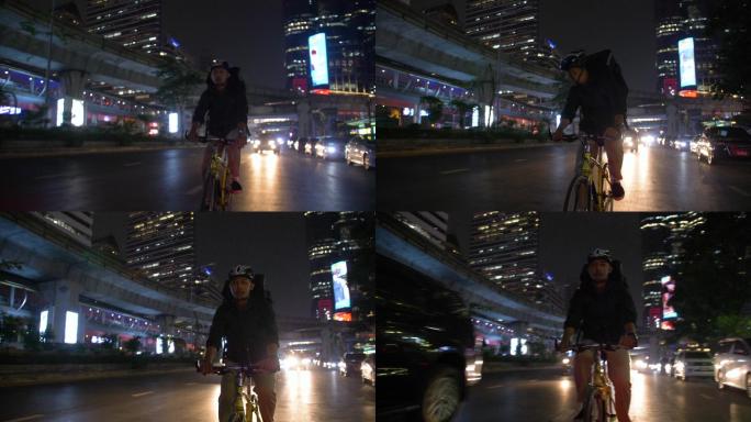 亚洲男人晚上骑自行车送货
