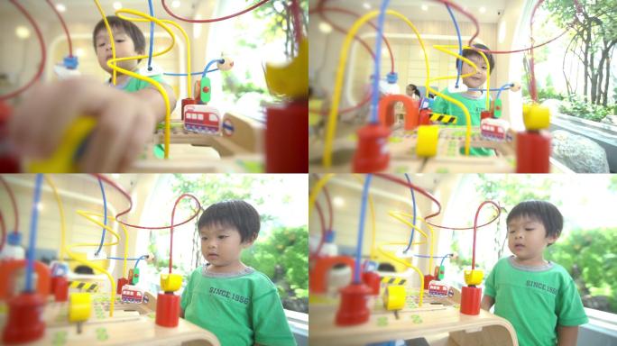 幼儿在游戏室玩算盘学习数学玩具