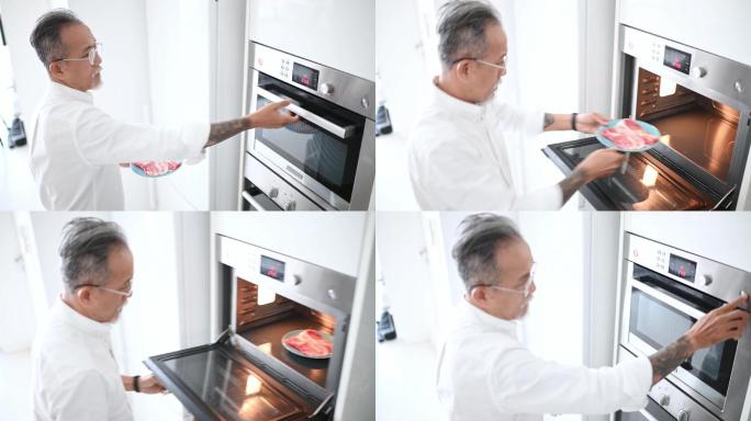 高角度亚裔中国高级男子早上在厨房用微波炉解冻肉类，准备早餐