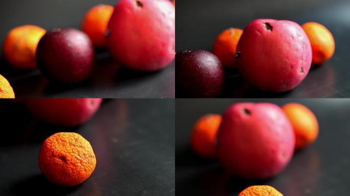 过期的水果苹果橘子李子黑色背景