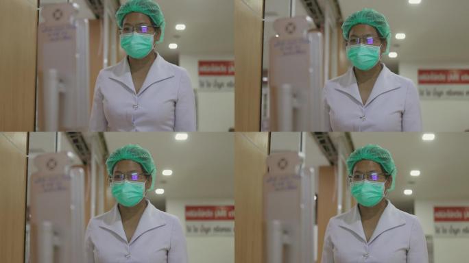 女性医务人员走近一点，站着不动，让摄像头可以聚焦并在智能触摸屏温度计上测量她的体温——库存视频
