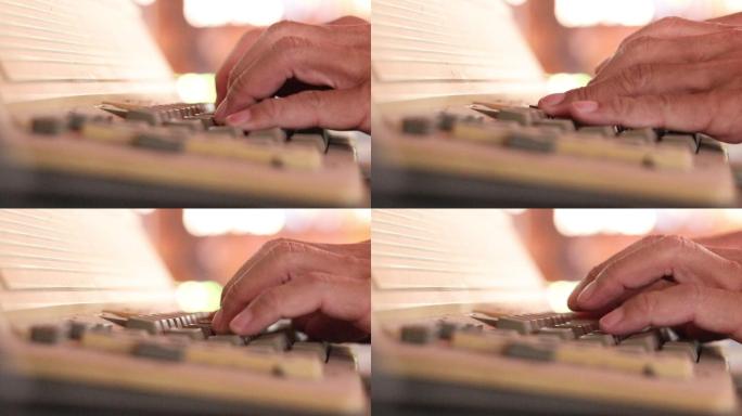 手指在旧打字机键盘上快速按字母的特写镜头。