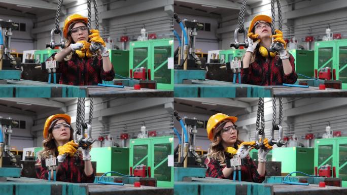 在工厂大楼工作的年轻漂亮的女工程师的肖像。
