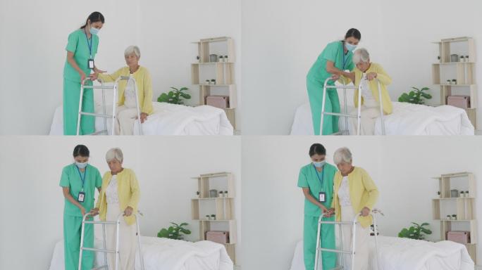 微笑的亚洲护士帮助老年妇女起床。护理人员在患者起床时为其提供支持，并在家中走向助行器。帮助年老的残疾