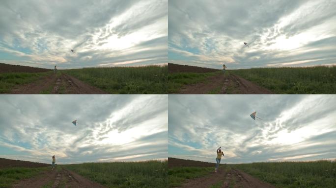 在麦田上空，一名女子在晴朗的蓝天下放风筝。童年的乐趣。在农田里奔跑。