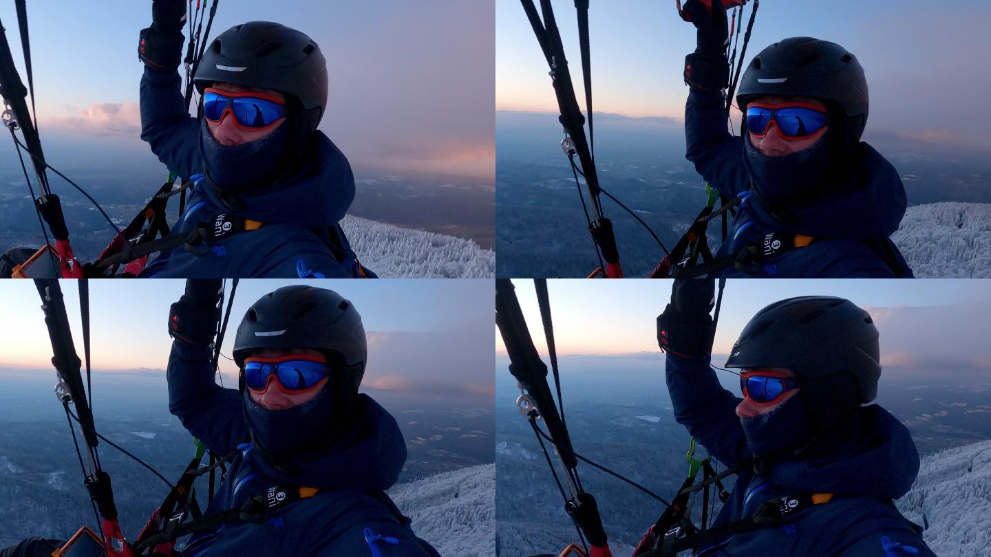 冬季日落时滑翔伞飞行时的山脉鸟瞰图