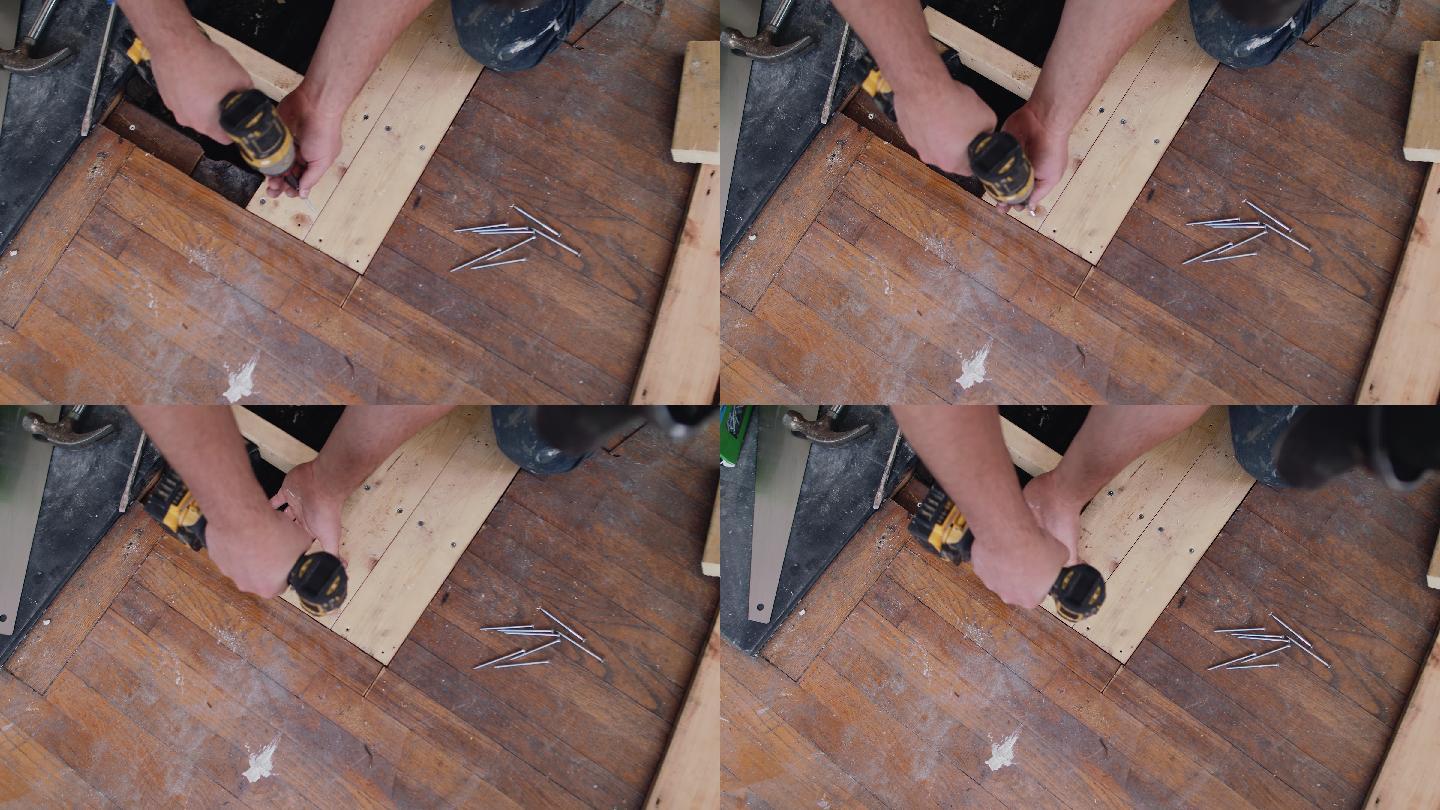 男性建筑工人使用电钻安装地板
